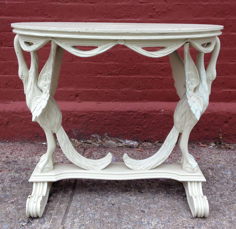 Carved pine table with intricately detailed stylized swans and drape design.  Painted white.