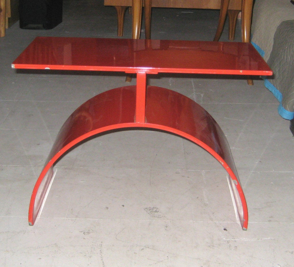 Gloss enameled fire engine red table has a strong Calder-esque sculptural design.  Solid iron and extremely heavy for its size. Unmarked