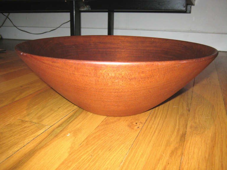 Large teak lathe turned bowl by studio Craft legend Paul Eshelman. Eshelman was part of the first generation studio woodworkers who sought to find artistic expression in simple, utilitarian objects. He was considered a master of form and graceful