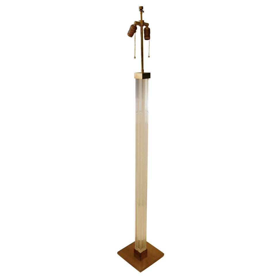 Tall incised lucite column on heavy brass base with brass cap and double socket cluster.