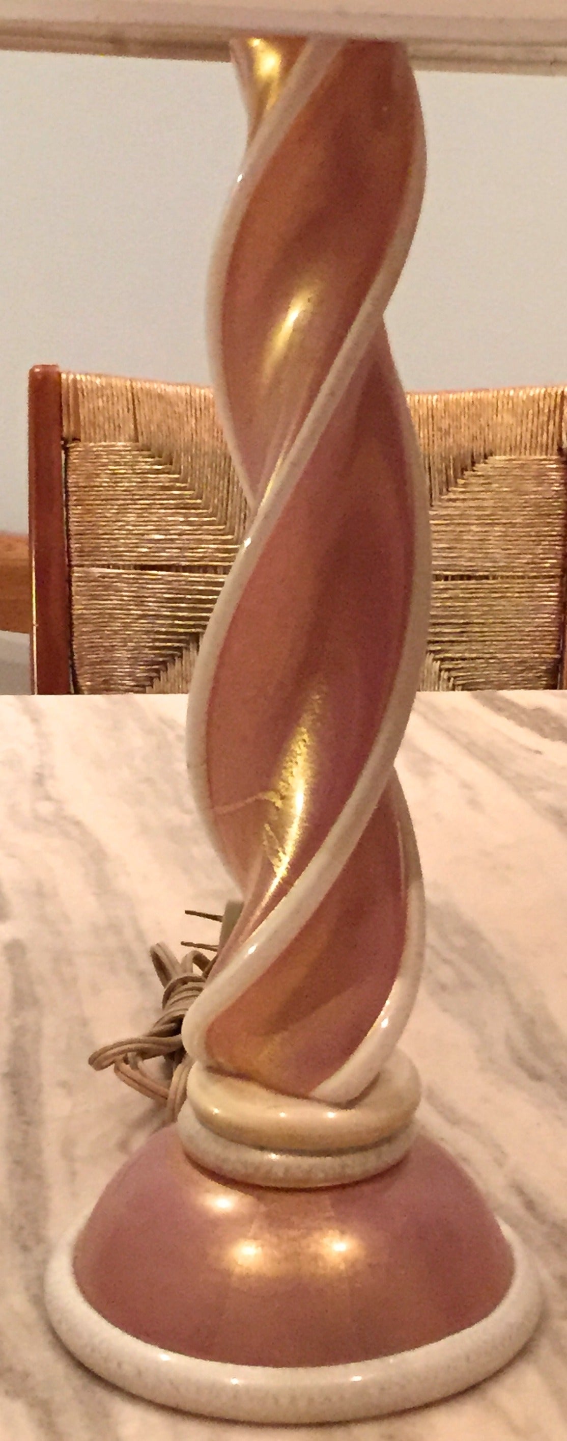 Rare and extraordinary table lamp. Twisted stem on dome base. Irridescent pink incamiciato glass with white applied 