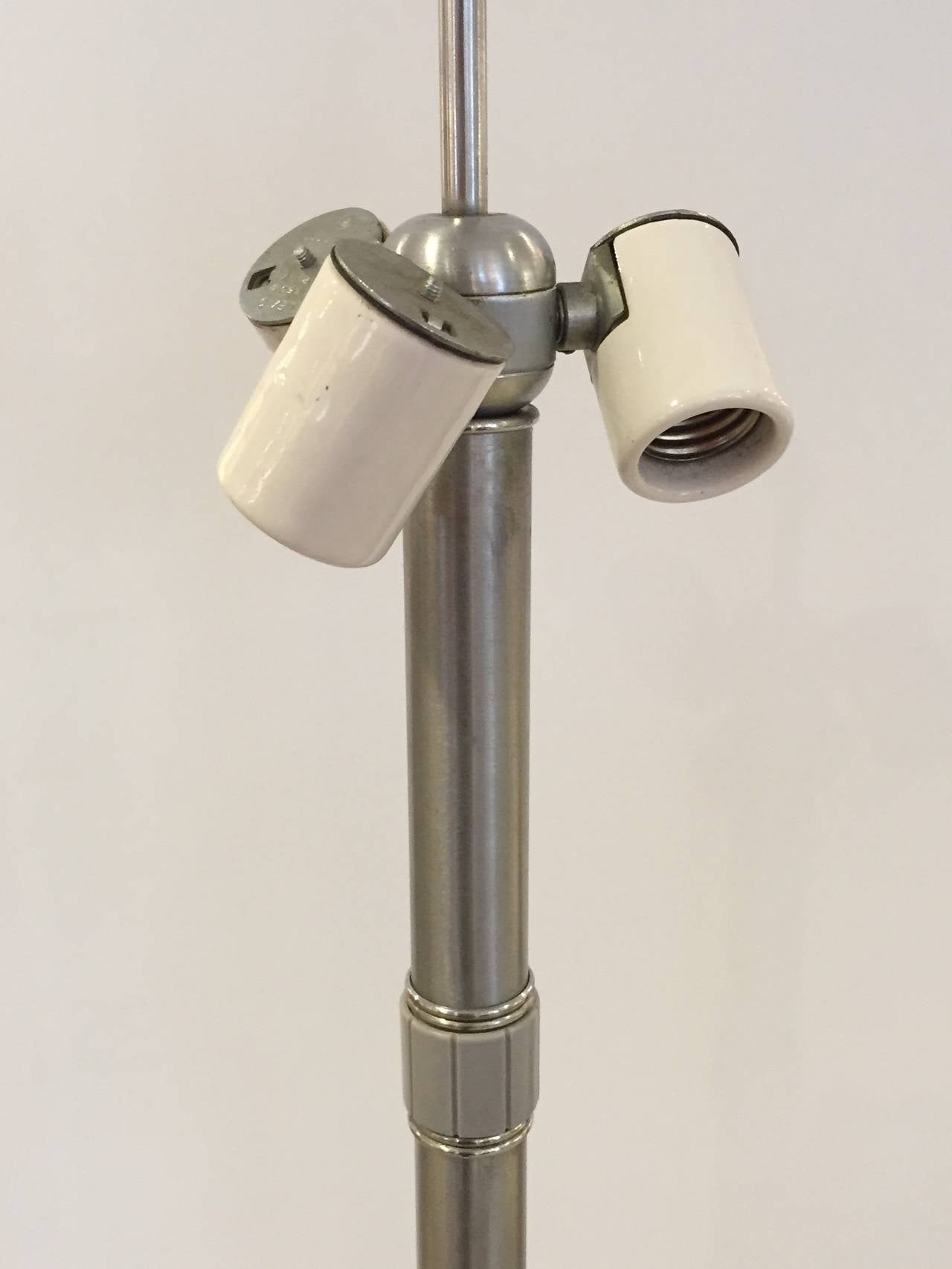 Early, simple Machine Age design. Brushed nickel stem and base with rotating three-way switch. Stamped Hansen.