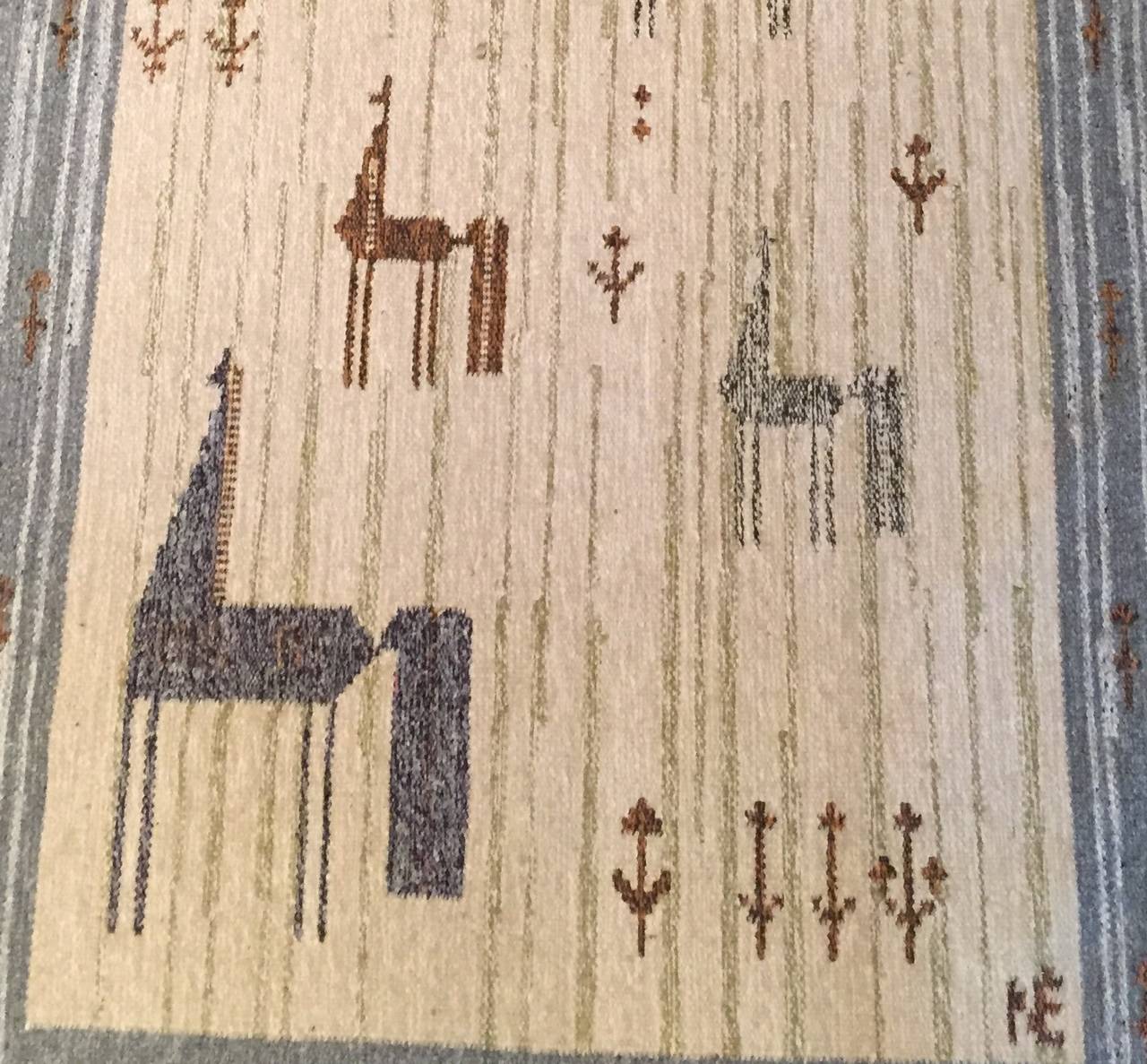 Wool rolakan of five stylized horses and wild-flowers in neutral tones. Attributed to a Finnish designer. Weavers initials on the bottom right corner.