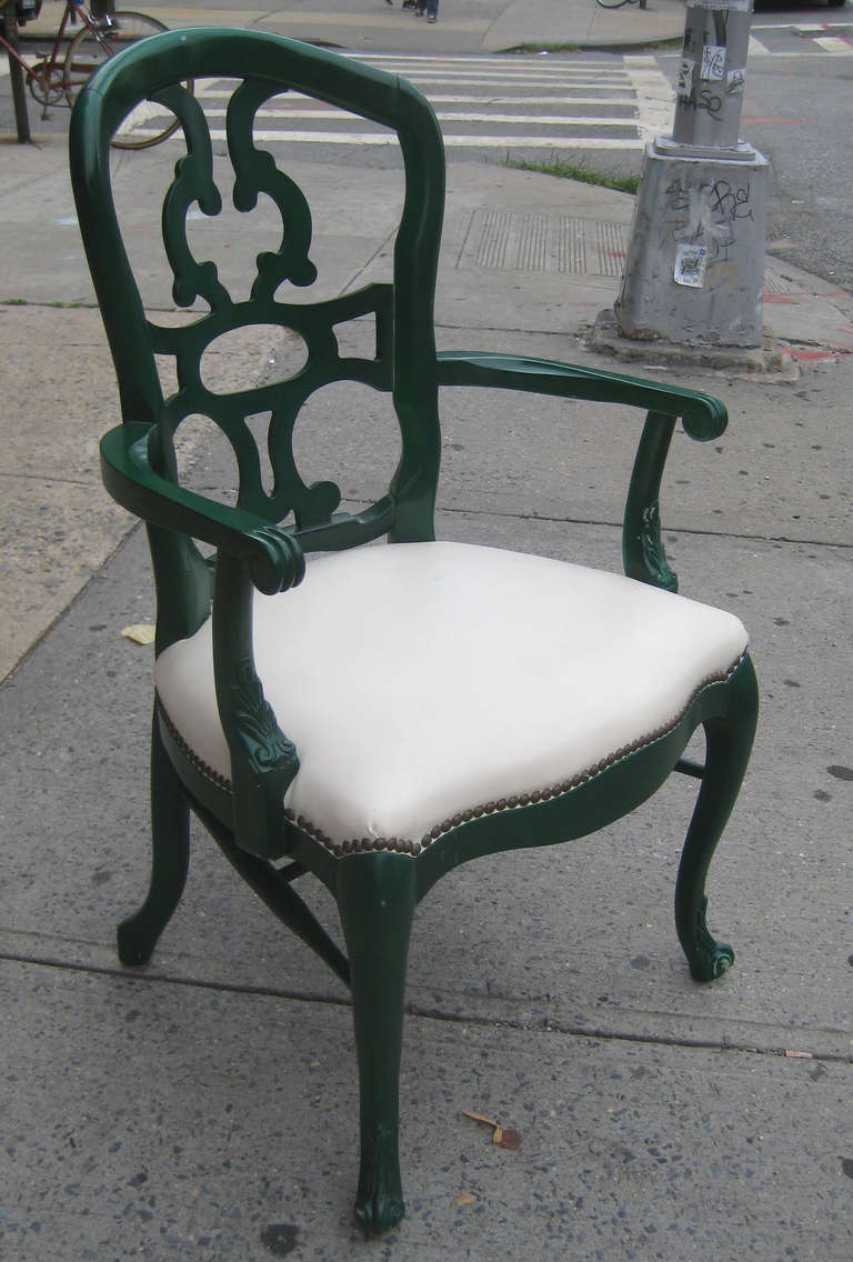 Rare arm chair was produced expressly for the public rooms of the Greenbrier hotel in the 1940s, and was never put into production.  Green lacquered wood frame with cream leather seat and brass rivets.  An example of this chair was included in the
