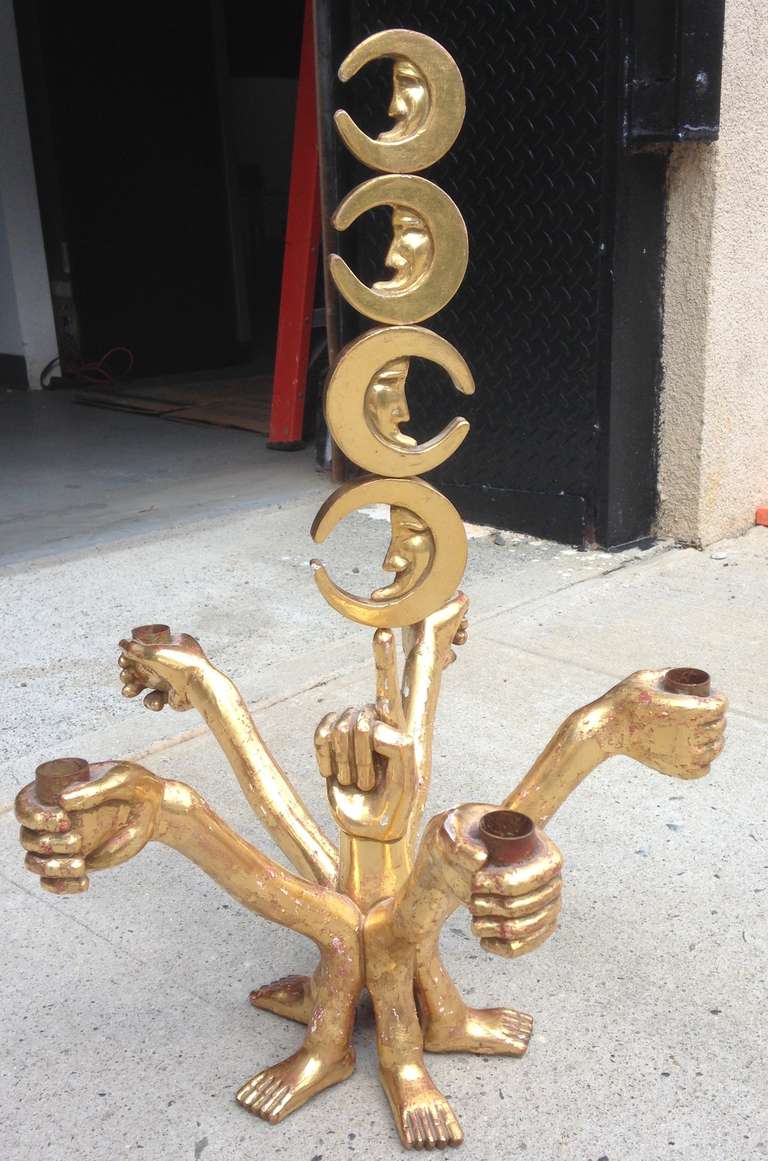 Rare early work consists of hand-carved and gilded five stem candelabrum in the form of surrealistically joined hands and feet. Can be hung via the moon stem or used on the table. Signed.