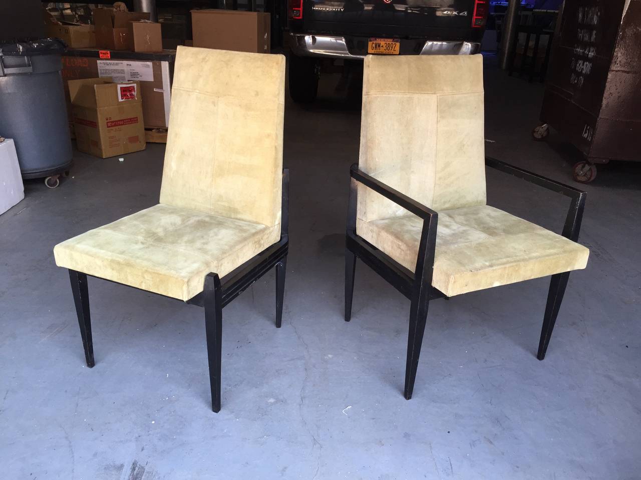 Architectural design chairs with rosewood frame and floating upholstered seat. Lovely brass details and wood carving. Pair of captains chairs and four side chairs. Can provide set of eight which require new upholstery. Original suede is in nice