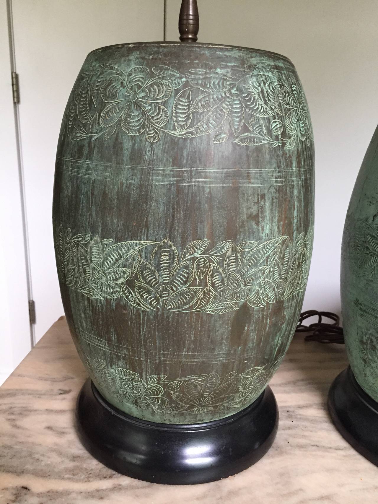 Bronze drum-shape bases etched with bands of fern decoration and deeply patinated with a vibrant green verdigris finish. Bronze drums are 14