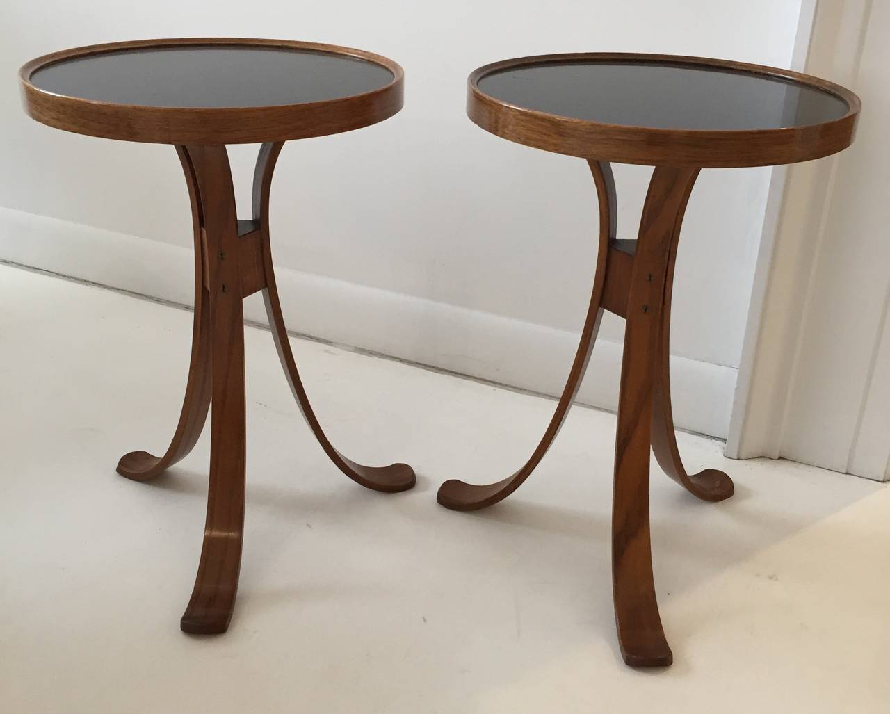 Elegant Edward Wormley design.  Described in the Dunbar catalog as snack tables, these are rarely found in a pair.  Bentwood legs, with walnut-rimmed black laminate table tops. Dunbar labels to each example. Priced per pair.