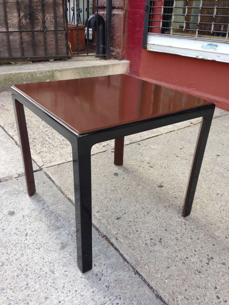 Designed in the mid-1940s for the estate of Jean Howard and Charles K. Feldman, this sweet little table has beautiful proportions and detailing with angled legs and raised top. Black painted lacquer frame, with brown lacquered surface and interior