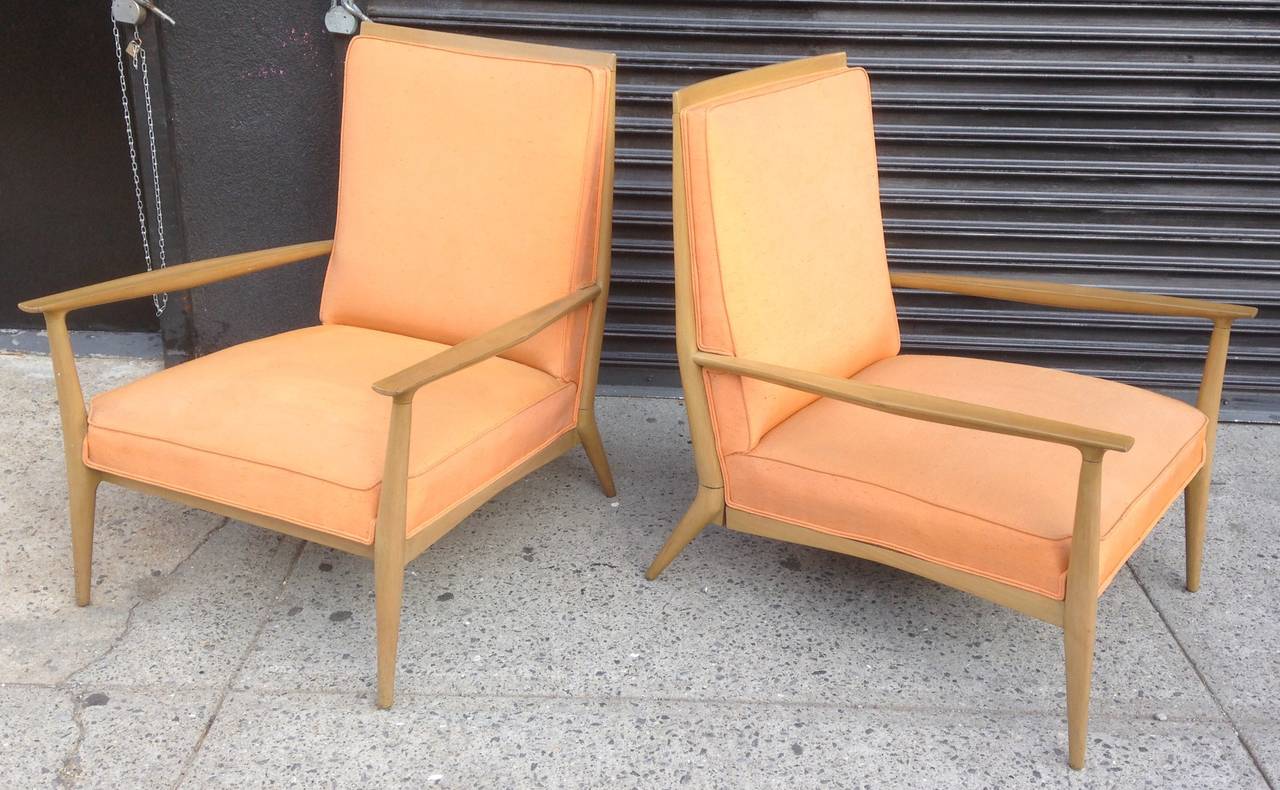 Classic and somewhat rare pair of armchairs in walnut with original peach silk upholstery. Great lines and nicely proportioned.