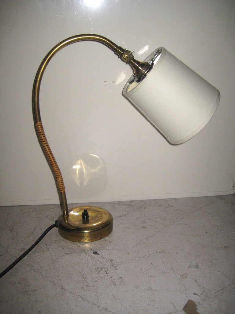Brass desk lamp with cane banding and paper shade with brass diffuser. Stamped 
