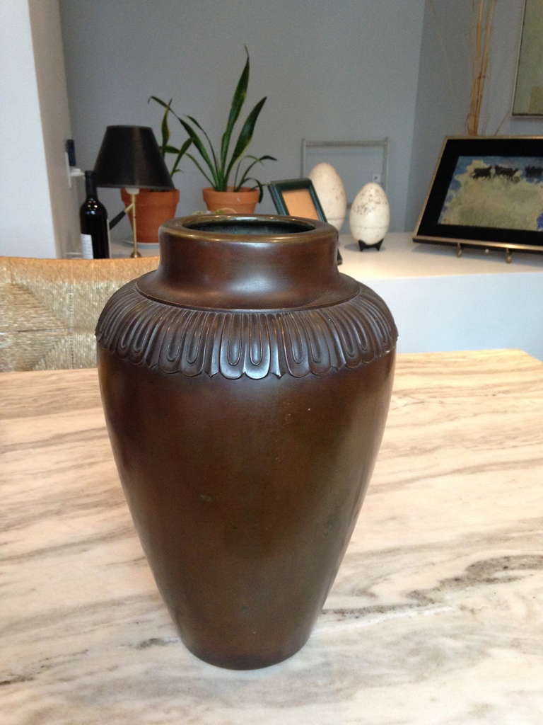 Beautiful proportions and rich original patina distinguish this simple urn form with stylized Art Deco petal design on rim.