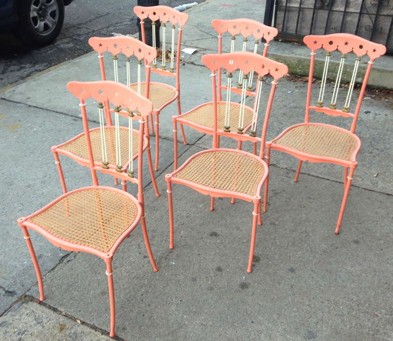 Graceful neoclassical Italian lacquered metal and brass chairs with hand-caned seats.