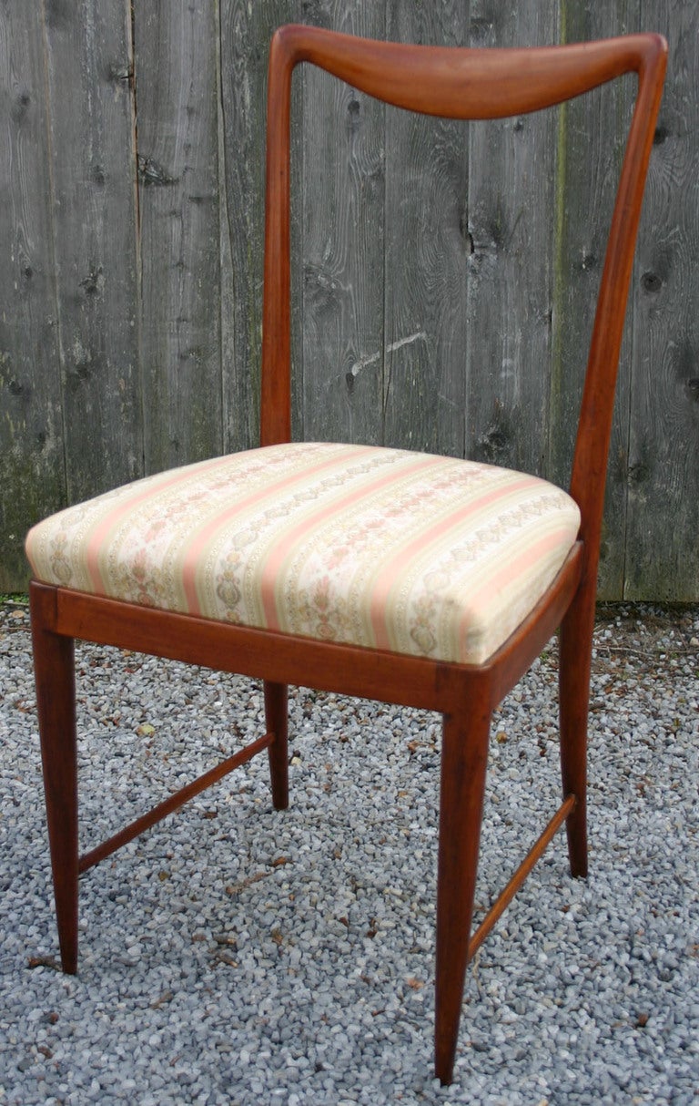 Set of six wood frame dining chairs with vintage upholstered seats. 