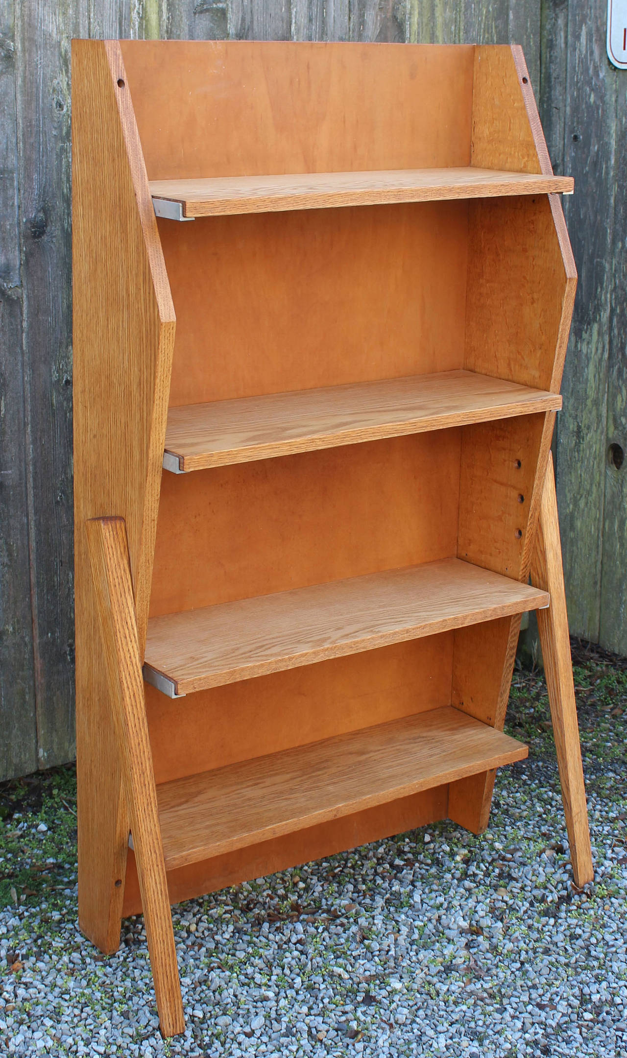 A French industrial modern style oak book shelf with extended support legs and steel details, in the manner of