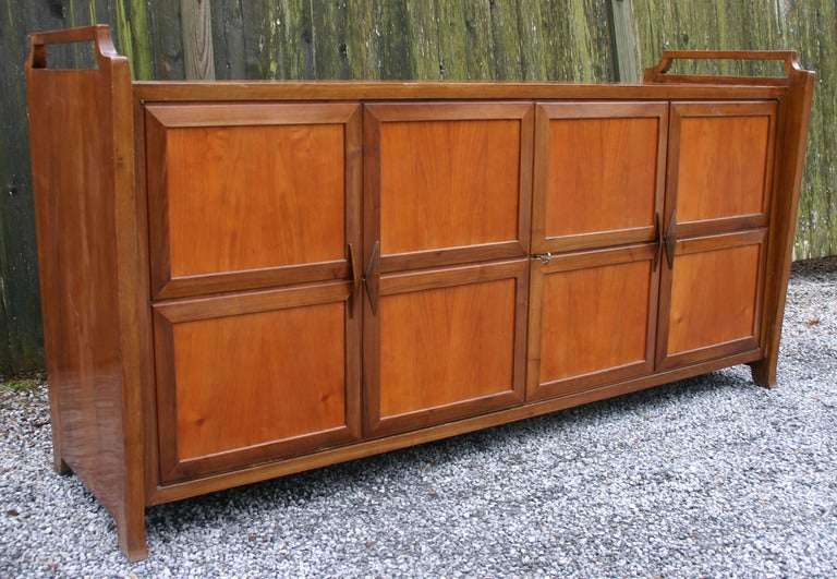 Gorgeous walnut bar-stereo cabinet with folding doors and blonde wood interior. The ultimate mid-century home entertainment system.