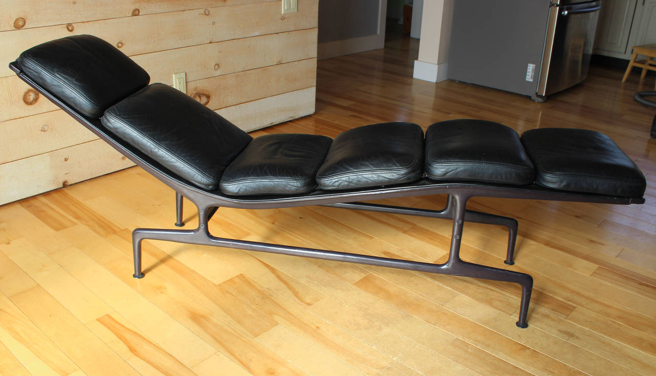 The Billy Wilder chaise in black leather by Charles and Ray Eames. Inspired by Billy Wilder, who asked the Eames' to design a narrow chaise. The first one produced was gifted to Wilder. This one is all original early production complete with two