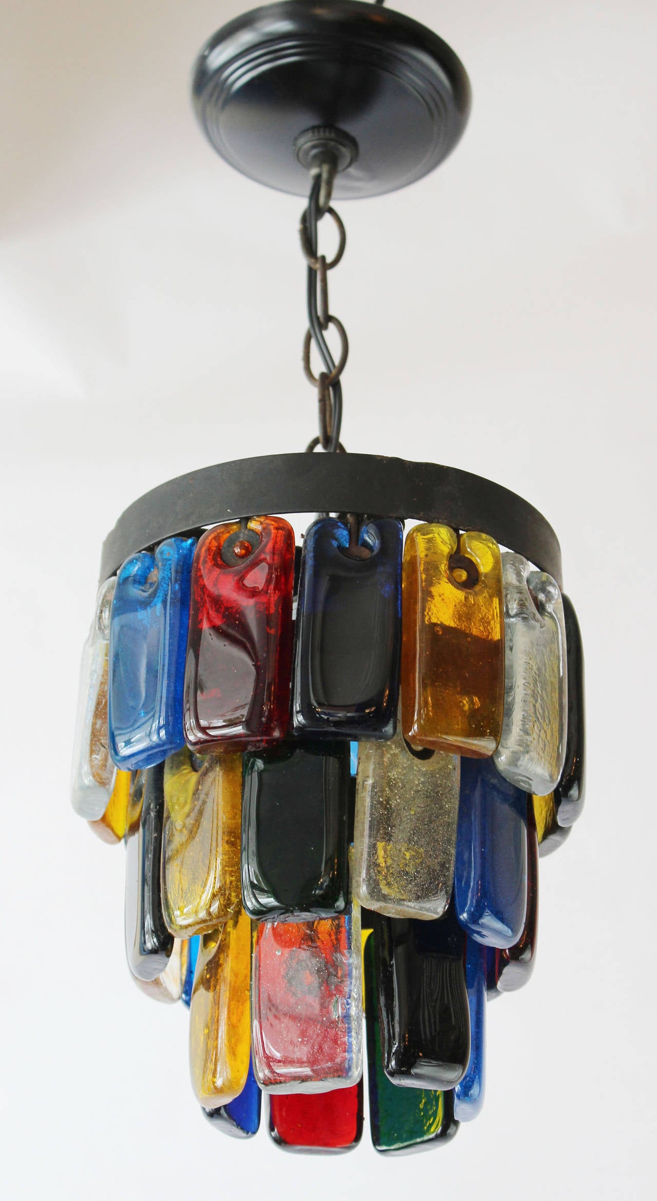 A pair of multicolor molded glass and iron three-tier pendants on iron frame.
Up to 75 watts porcelain socket.

5 inches -- chain and ceiling cap.