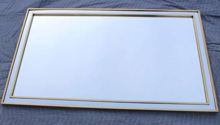 Handsome, solid brass and recessed chrome frame mirror.