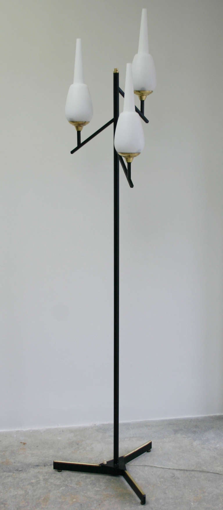 Exceptional sculptural milk glass 3-head iron base florr lamp with brass details. rewired and polished.