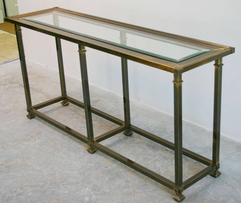 Regency style, patinaed brass and bevelled glass console by Mastercraft.