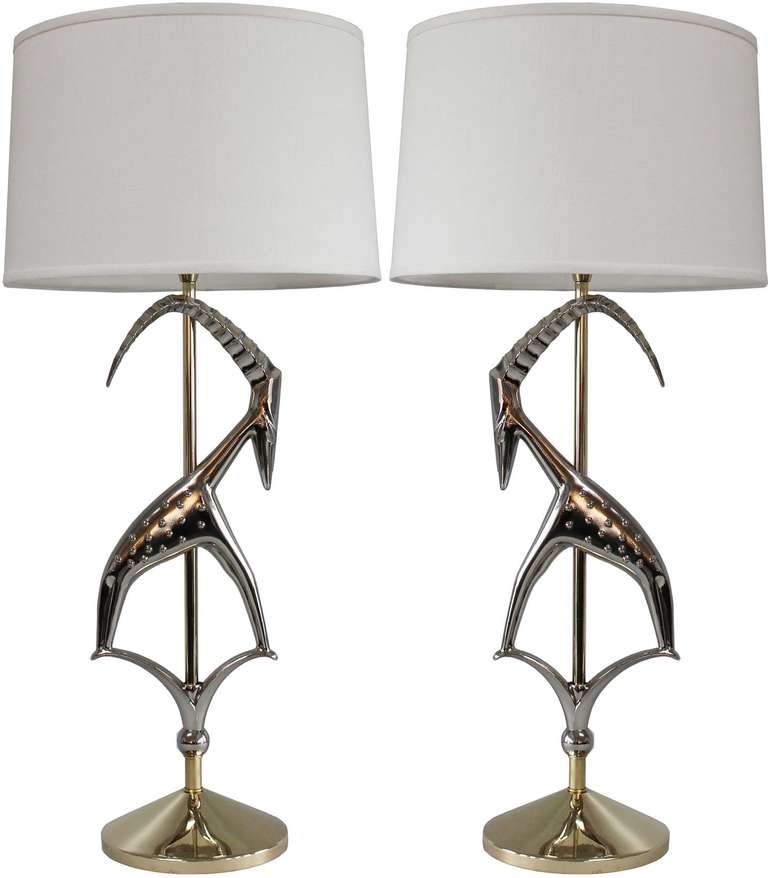 Pair Nickel and brass antelope lamps with milk glass diffusers. 

shades not included.