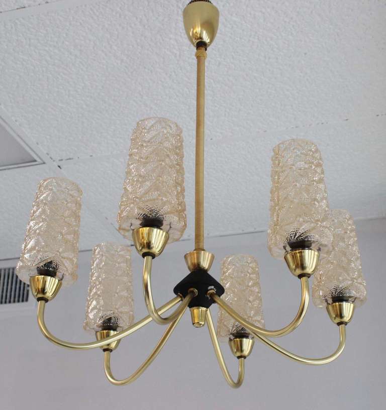 Elegant glass and brass chandelier with black enamel and woven silk rod details.
Glass shades are each 6.5