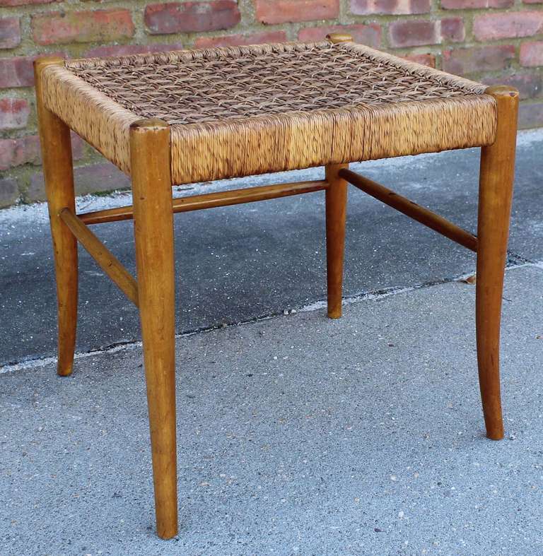 Maple frame ottoman, with woven rush seat and sabre legs, attributed to Robsjohn-Gibbings.