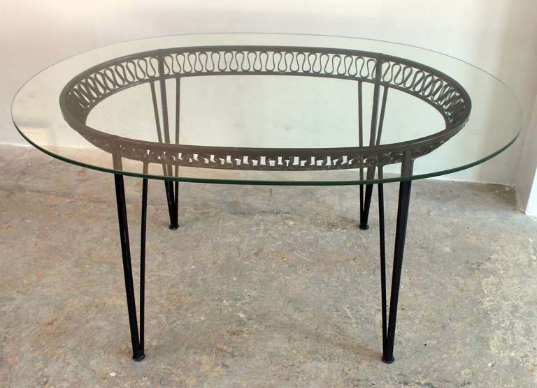 Classic ribbon design iron indoor-outdoor table with glass top, designed by Tempestini for Salterini.