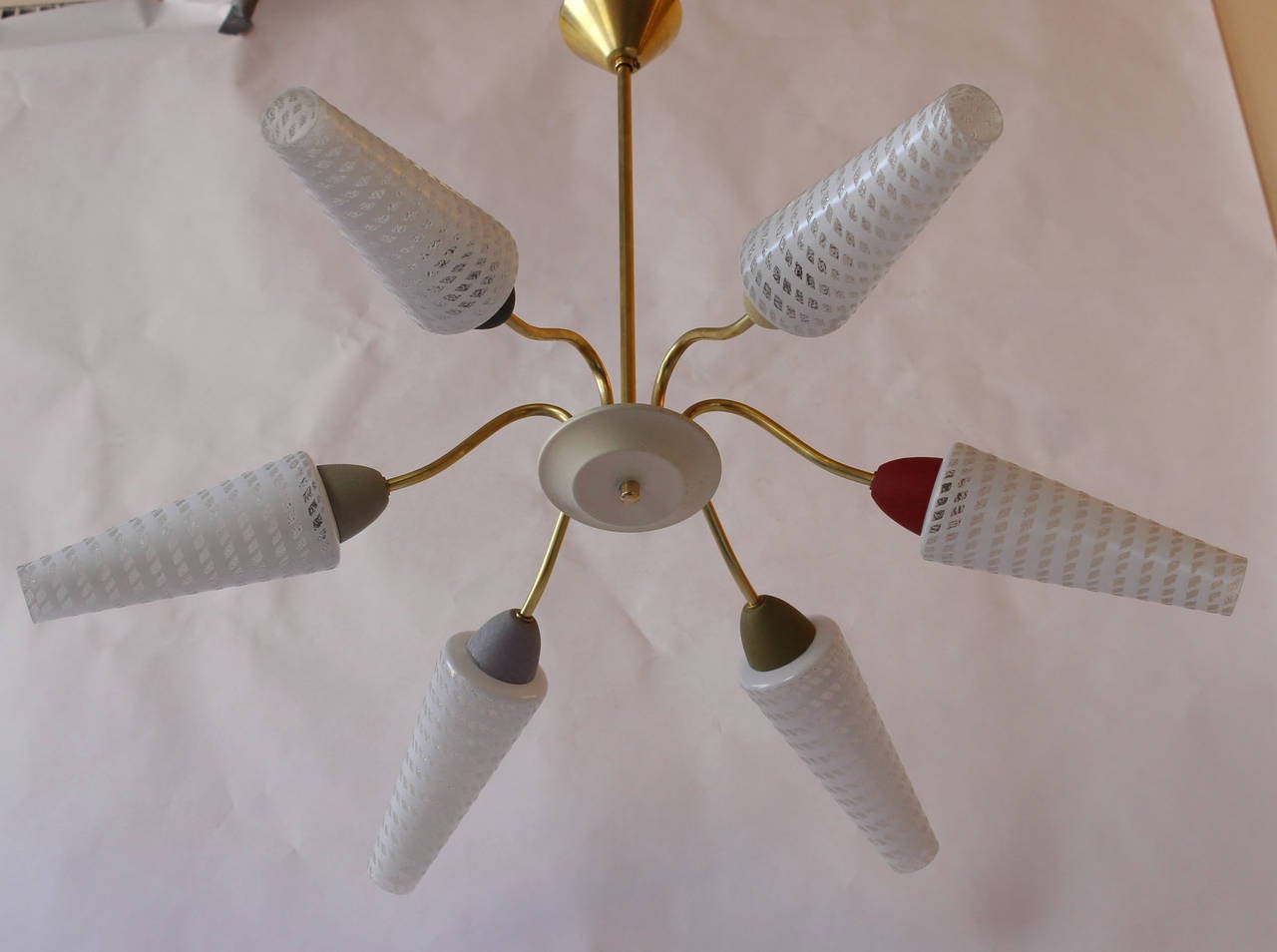 A modern Italian brass and multicolor enamelled metal chandelier with white and clear glass diffusers.