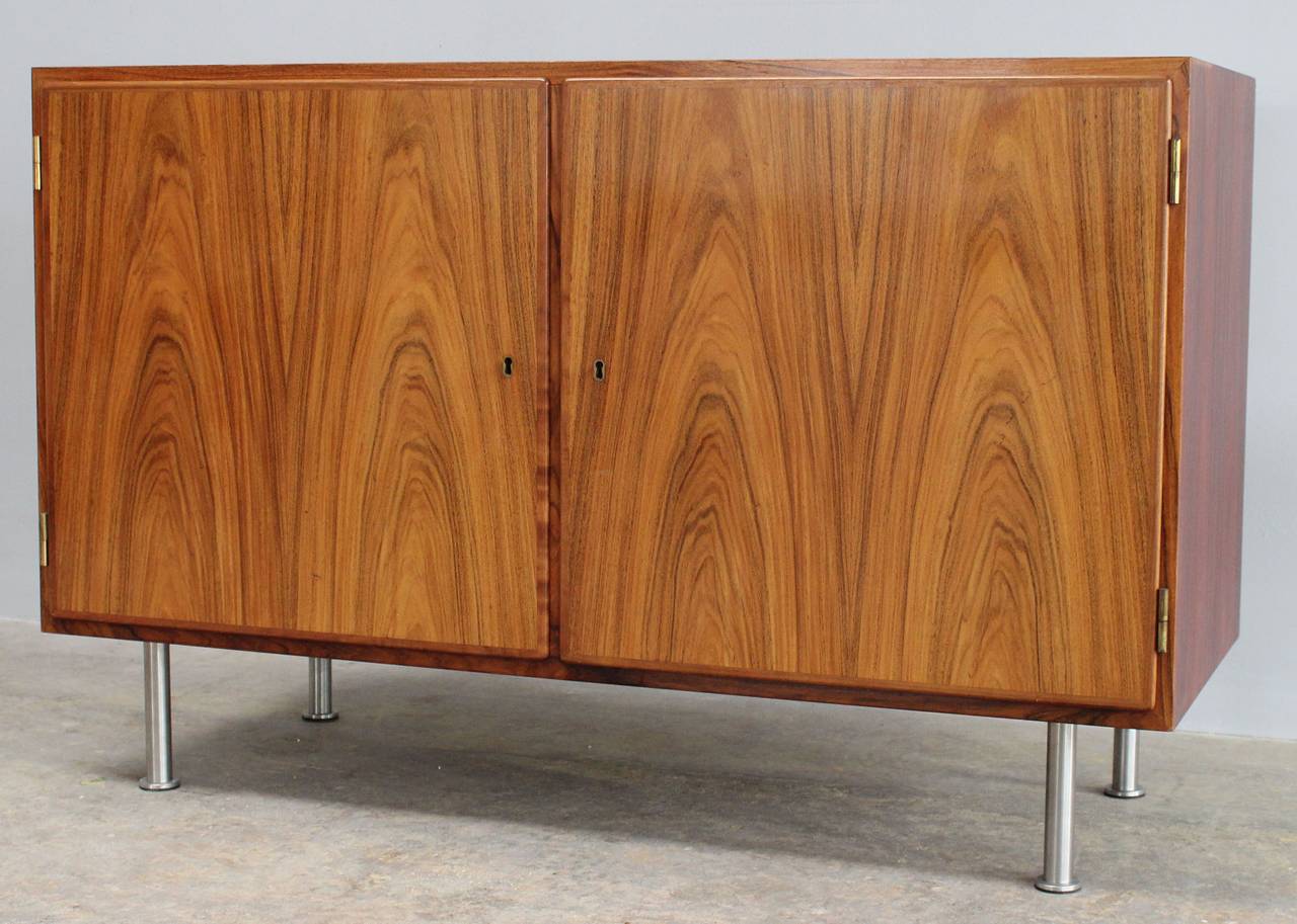 A Danish rosewood cabinet or sideboard with steel legs and adjustable drawers.