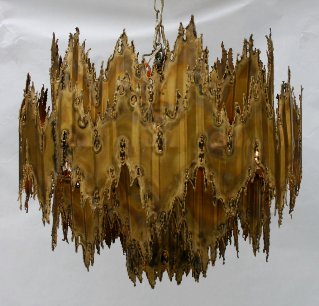 Hand crafted torch cut and patinaed brass chandelier by Tom Green. Seven Sockets