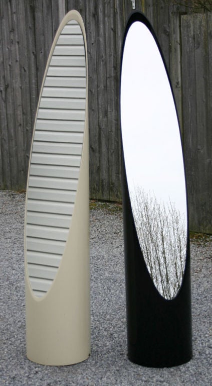 Sleek and mod floor mirrors by Roger Lecal for Charbrieres France 1970's. Cylinder of lacquered PVC cut on an extreme bias, inset with a slender oval mirror.  Price is for single mirror.