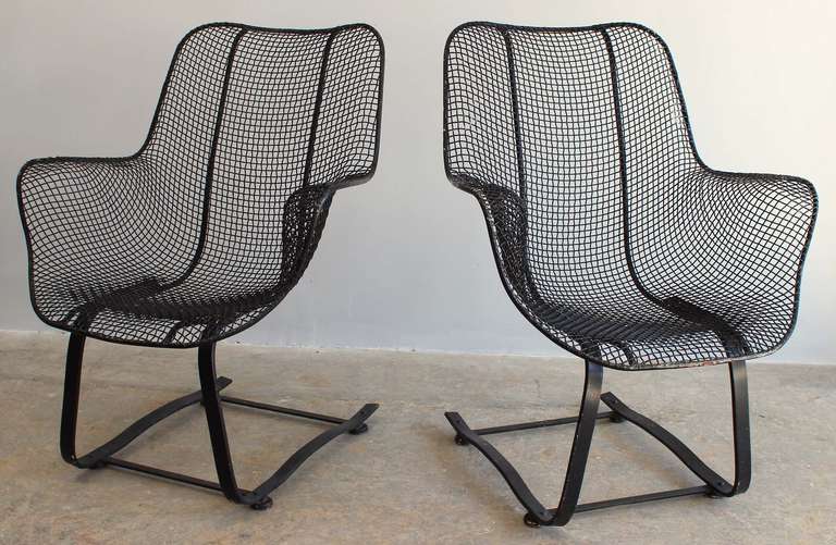 Pair iron and mesh cantilever armchairs by Russell Woodard.