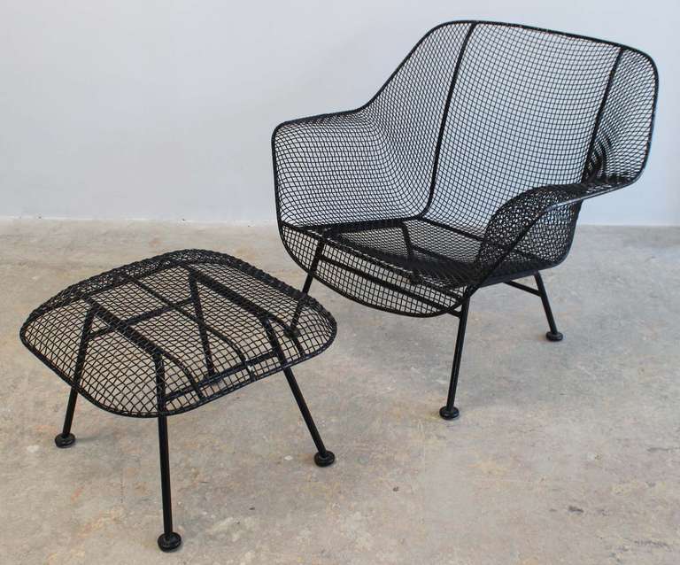 Roomy iron and mesh lounge armchair and ottoman designed by Russell Woodard.