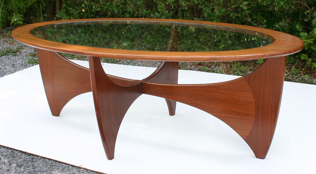 Sculptural teak and walnut oval coffee table with glass plateau, attributed to Ib Kofod-Larsen.