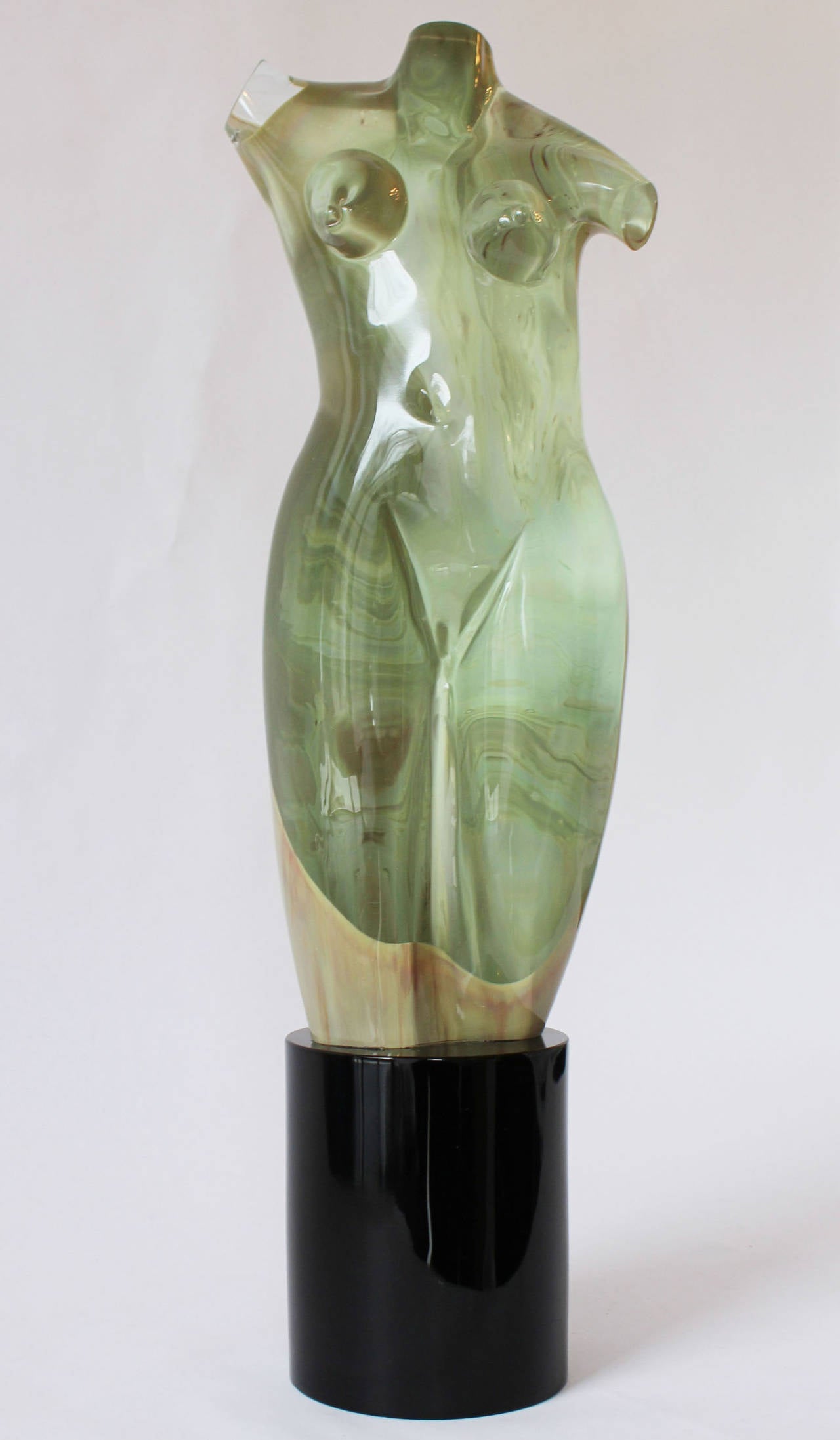 A beautifully executed solid Murano glass sculpture, clear, with marbleized cased glass details and 6 inch high black glass base, attributed to Pino Signoretto.