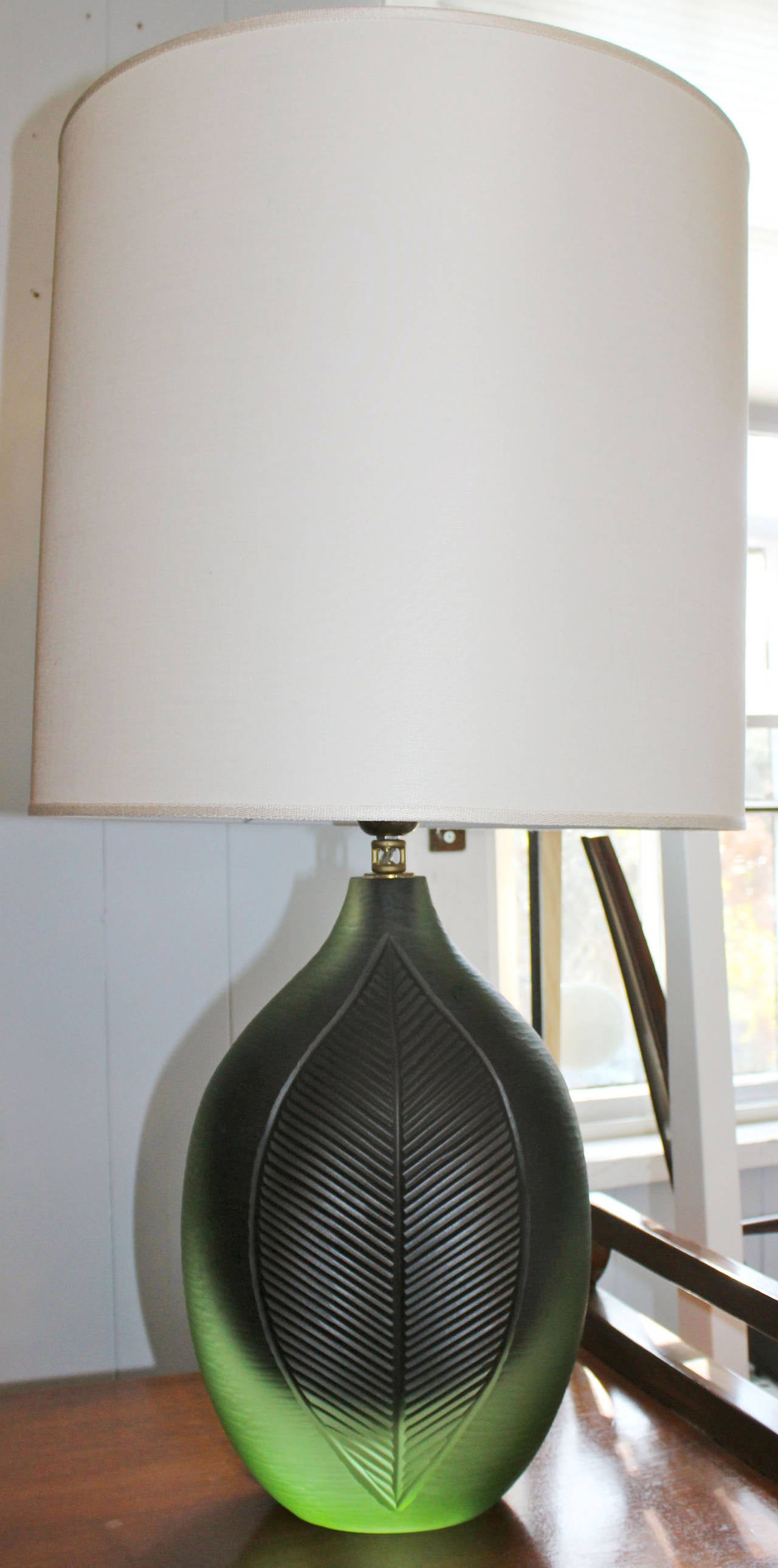 Solid dual-tone green solid molded glass with incised leaf detail and brass hardware. 

lampshades included. 16