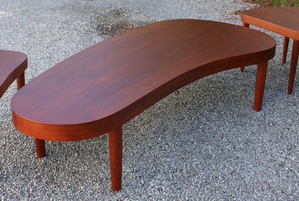 Biomorphic shape teak coffee table by Poul Dinesen. Matching end tables also available (see pictures).
