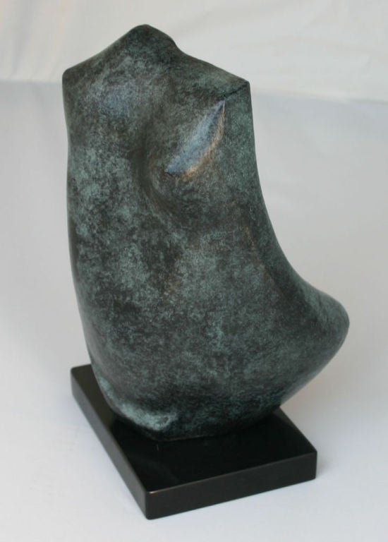 Small female torso of patinaed cast bronze on black stone base, by Thomas Ogle (b Finland (1938-)