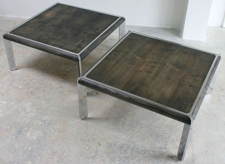 A pair of solid chromed steel frame tables with rubbed driftwood style tops and sidebars. Great as double coffee table or end tables.
