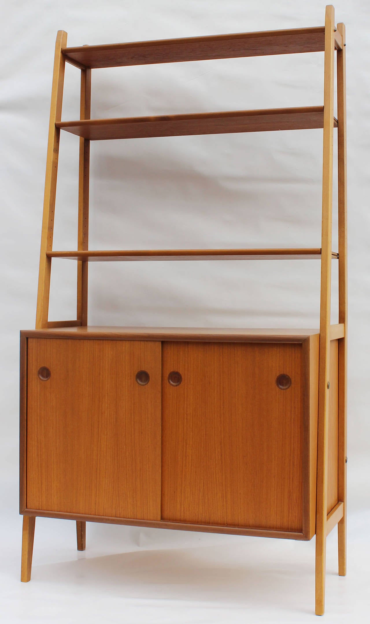 A pair of Swedish teak cabinets with adjustable shelves.
