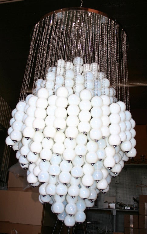 Impressive Murano white milk glass ball sconce with chrome chain and crown. Pair sconces also available