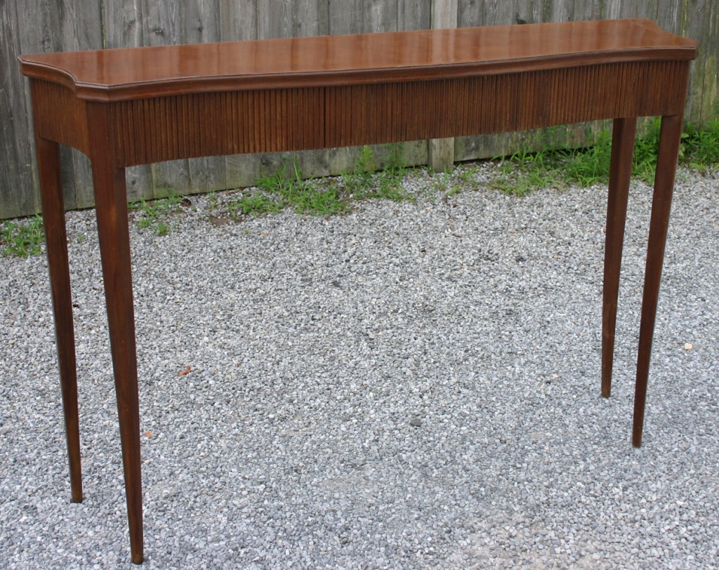 Distinctive dark walnut finish console with one drawer and contoured glass top attributed to Paolo Buffa.