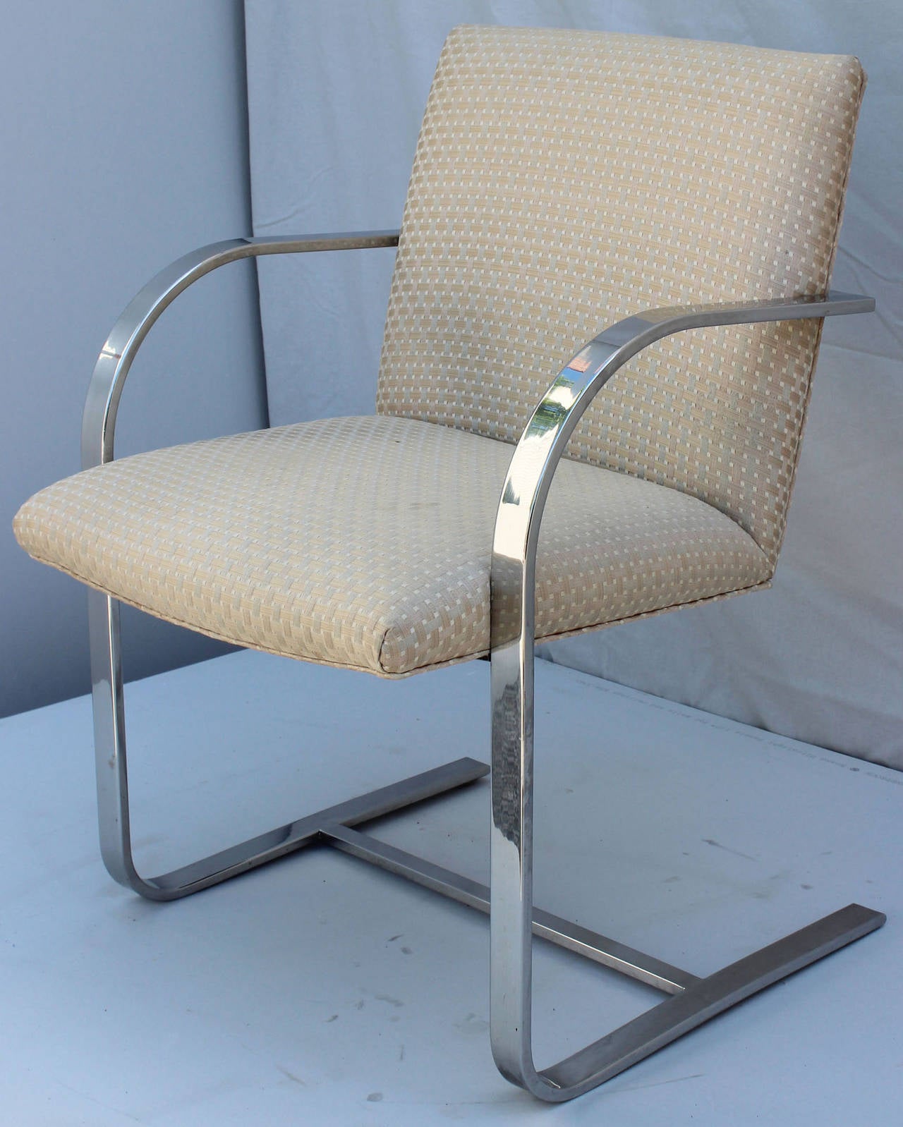 A set of six chromed steel chairs in vintage upholstery in the manner of Ludwig Mies van der Rohe.