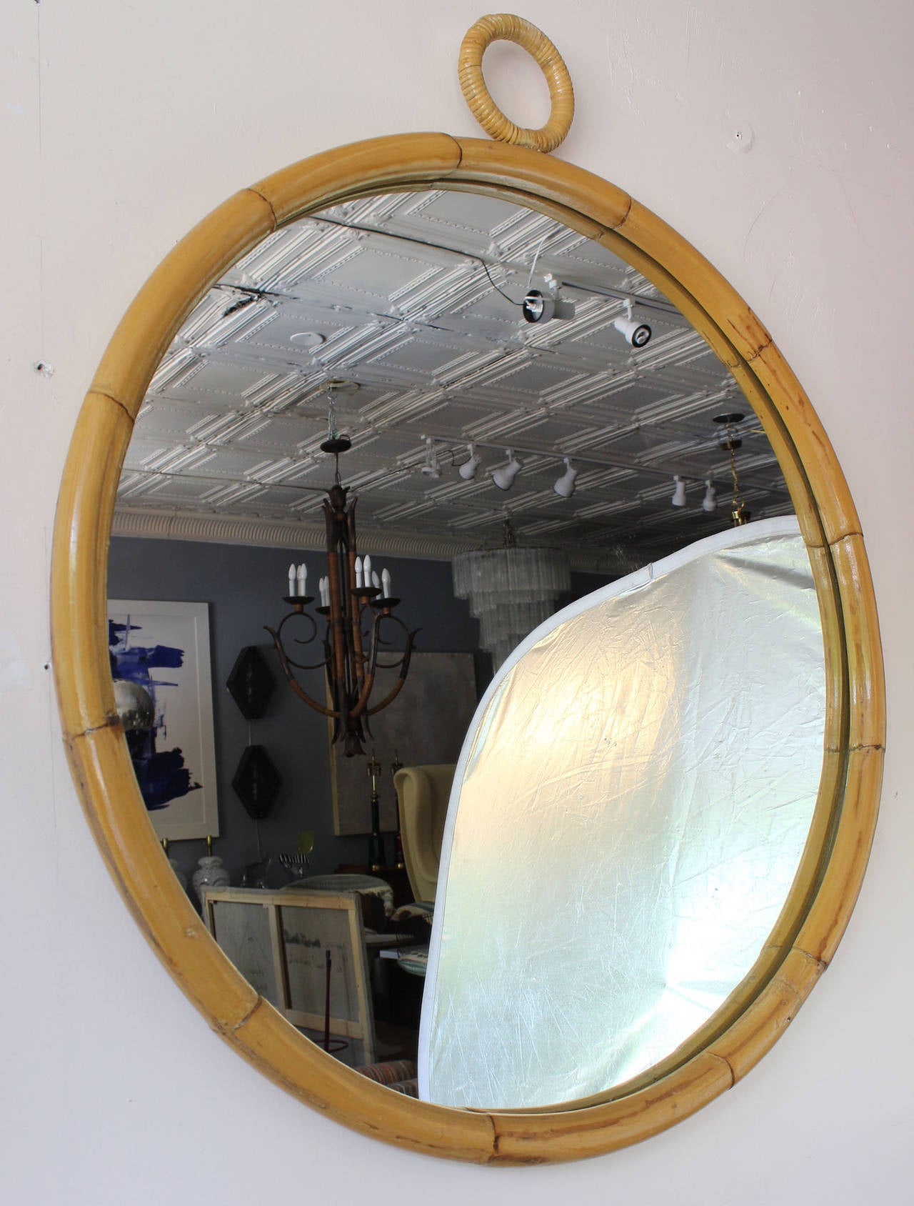 A round bamboo frame mirror with wrapped rattan detail.