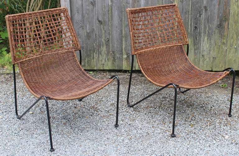 A sculptural pair of iron and woven rattan indoor/outdoor lounge chairs by Van Keppel-Green.