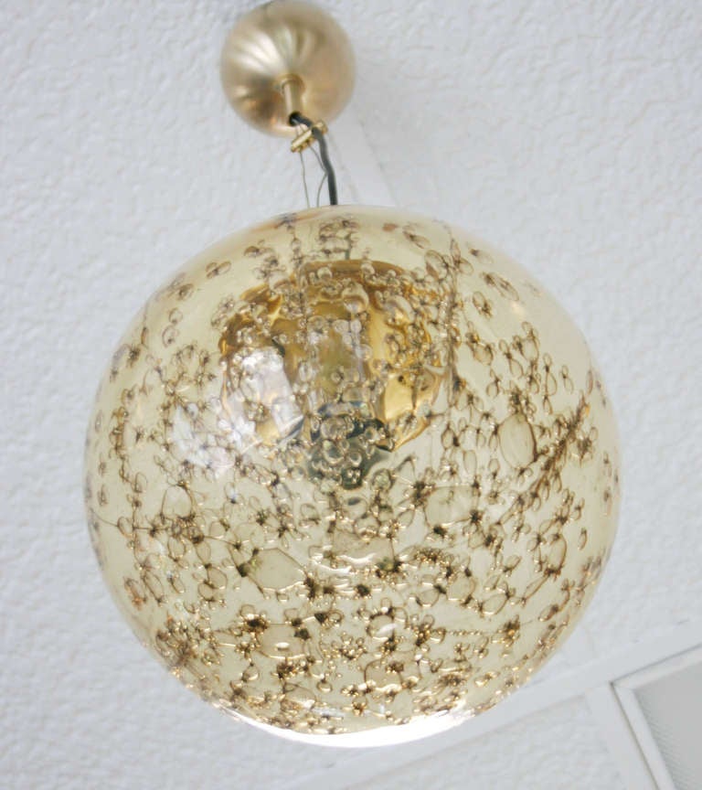 Hand blown champagne color floral bubbles glass with brass hardware.