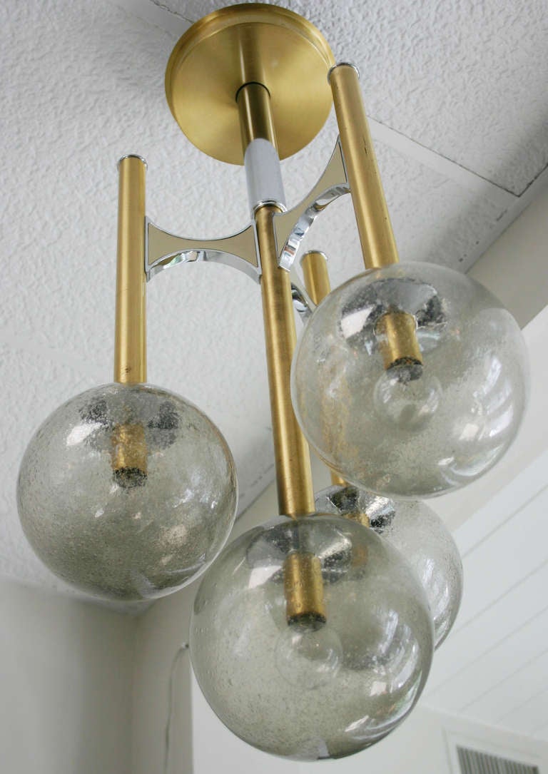 Spectacular four champagne globes, brass and chrome pendant, by Gaetano Sciolari.
Glass globes are each 7