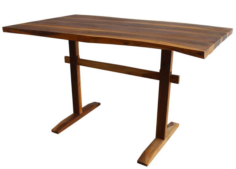 A natural edge walnut trestle writing table or desk in the manner of George Nakashima. From an estate with many Nakashima pieces.